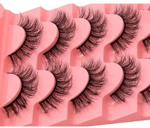 Vue macro de 8 paires de faux cils 3D effet vison volumineux sur plateau rose