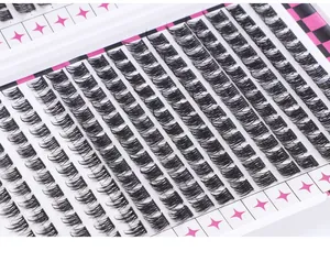 Macro view of individual eyelash clusters in a D-curl arrangement on a pink star tray