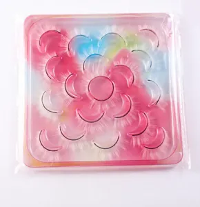 Detail of 10 pairs of dense long black synthetic eyelashes in a gradient pink and blue box