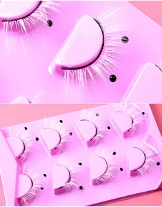 Macro detail of dense white false eyelashes with pearls for festive stage makeup