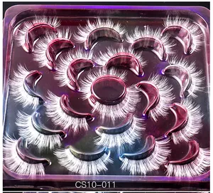Close-up of 14 pairs of white false eyelashes in a purple tray for festival makeup