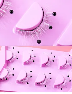 Close-up of pink and white false eyelashes with black pearl accents in an 8-pair pack