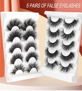 Detailed view of 5 pairs of voluminous, curly false eyelashes on white trays