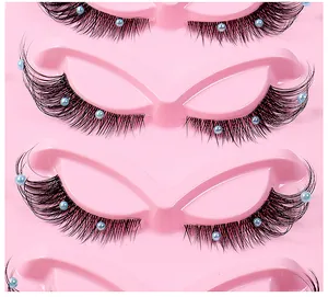 Macro shot of faux mink eyelashes with blue pearls on clear band in a pink tray