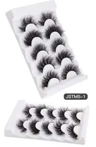 Detail view of 5 pairs of fluffy faux mink eyelashes on tiered white display trays