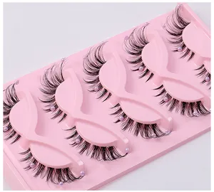 Macro detail of false eyelashes with purple pearl accents on a pink tray