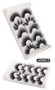 Detail view of 5 pairs of thick faux mink eyelashes with intense curl on a white tray