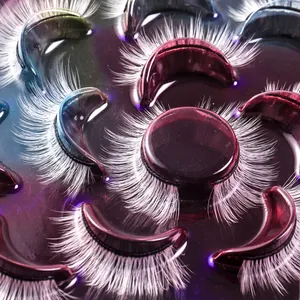 Dramatic white false eyelashes in a dense, curly style for festive stage makeup looks