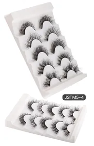 Detailed view of 5 pairs of thick curly mink style false eyelashes on white tray