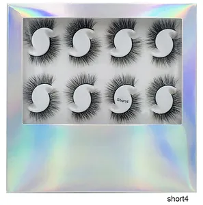 Detail of short multi-layered false eyelashes in a holographic box on a white tray