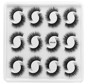 Detail view of 12 pairs of dense black faux mink eyelashes in model Short8 within a white tray