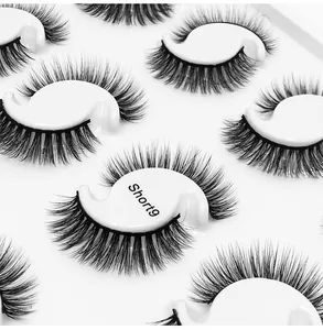 Macro detail of Short9 multi-layer dense black false eyelashes on white S-shaped trays