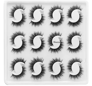 Detail view of 12 pairs of dense black short false eyelashes in a Short10 white tray