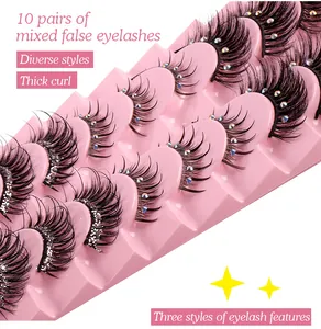 Macro detail of mixed false eyelashes with colorful rhinestones on a pink tray