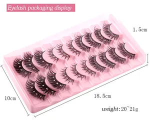 Macro detail of dense curly eyelashes with silver rhinestones in a pink display tray
