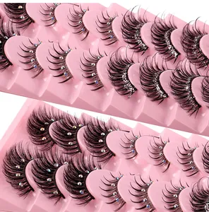 Macro detail of false eyelashes with rhinestones and glitter in pink display trays