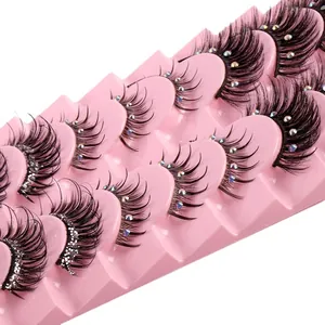 Thick curled false eyelashes with sparkling rhinestones on pink wavy display tray