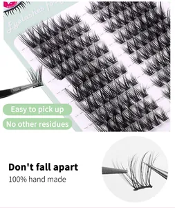 Detailed close-up of handmade segmented cluster eyelashes in a green tray with tweezers
