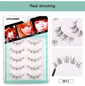 Macro detail of natural crossed false eyelashes with clear bands in a five-pair pack