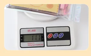 Eyelash extension kit in laser holographic bag weighing 111g on electronic scale