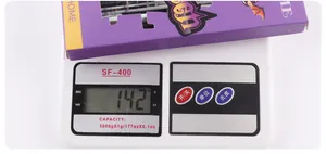 Detail showing the purple DIY eyelash extension kit on an electronic scale for weight check