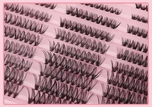 Macro detail of high-volume black cluster eyelashes arranged in a pink tray
