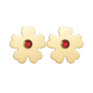 Gold stainless steel flower earrings with red ruby stone centers on white background