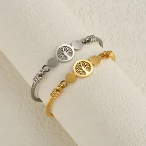 Set of gold and silver stainless steel wire cable bangles with Tree of Life charms