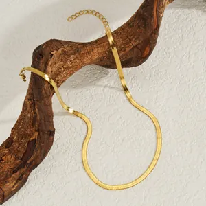 Elegant 18K gold plated herringbone snake chain necklace on minimalist wood display