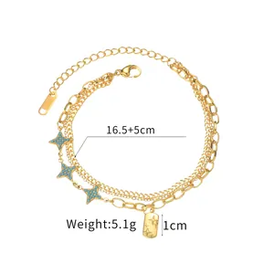 Detail of layered gold stainless steel bracelet with blue star charms and 16.5+5cm chain
