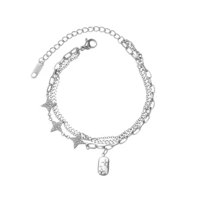 Detail of layered silver chain bracelet with star charms and adjustable lobster clasp