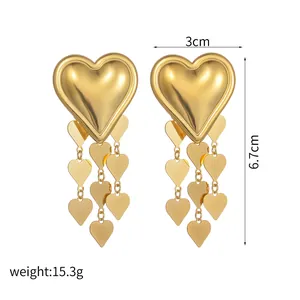 Detailed view of large gold heart studs with tassel fringe showing size 3cm by 6.7cm