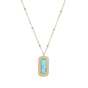 Detail of 18K gold necklace featuring a rectangle turquoise stone with embossed patterns