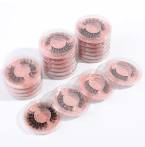 Detailed close-up of multiple round cases showing varied dense synthetic false eyelashes