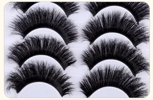 Detailed macro view of 5 pairs of fluffy dense black false eyelashes on a white tray