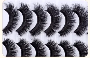 Detailed macro view of dense criss-cross layered fluffy false eyelashes on tray