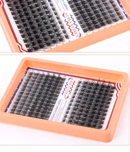 Macro detail of individual cluster lashes in 8-18mm mixed lengths on an orange tray