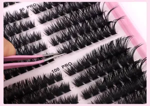 Macro detail of 540 cluster lash set with pink tweezers for professional eye makeup application