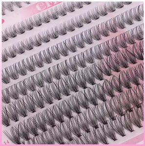 Close-up of 14mm individual cluster eyelash extensions on a pink storage tray