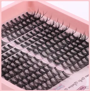 Macro detail of individual cluster eyelashes in pink tray showing soft fiber texture