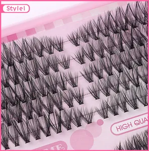 Macro view of high quality dense black cluster eyelashes on a pink dotted background