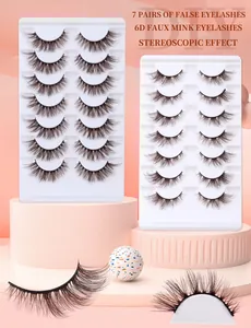 Detailed macro view of 7 pairs 6D faux mink false eyelashes in a stylized orange setup