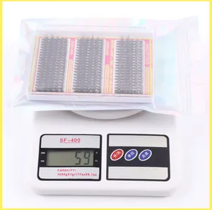 Detailed view of individual lash clusters packaging weighing 59g on a digital scale