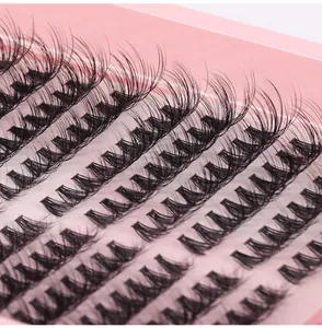 Macro detail of natural black D-curl individual lash clusters in a pink tray organizer