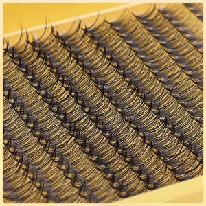 Macro shot of natural black 10D 20D 30D cluster eyelashes on a yellow tray
