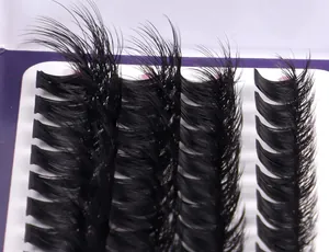 Macro close-up of fluffy black DIY cluster lash extensions on white tray with curl detail