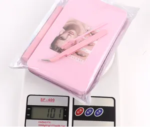 DIY eyelash extension kit in pink storage box on scale weighing 101 grams accurately