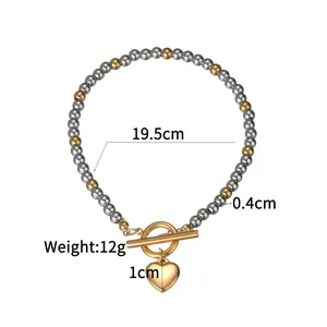 Silber-Gold Perlenarmband mit Herzanhänger zeigt Größe 19,5cm und Gewicht von 12g