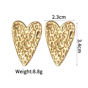 Detail view of large heart studs with 18K gold hammered texture finish and dimensions