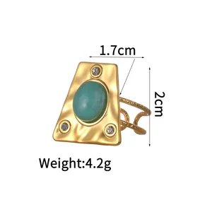 Detail view of 18K gold plated hammered ring with turquoise stone and crystal inlay